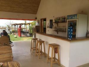 a bar in a restaurant with stools and a counter at Terra Lodge Sénégal in Mbour