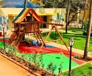 a playground in a park with a play structure at kesinovo suites in Anjuna