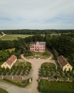 an aerial view of a large pink house with a driveway at Hoby Kulle Herrgård B&B in Bräkne-Hoby