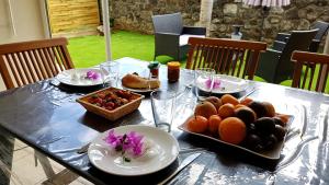 a table with a tray of fruit on it at La Perle Marine in Saint-Leu