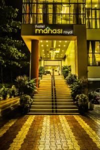 a hotel with a staircase leading into a building at Hotel Manasi Royal in Satara