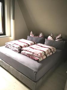 a bed with pillows on it in a room at Rosenblick in Zingst