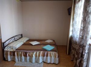 a bedroom with a bed with two towels on it at Aparthotel Flora in Kharkiv