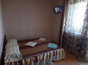 a small bed in a room with a window at Aparthotel Flora in Kharkiv