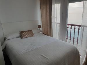 een slaapkamer met een bed en een raam met uitzicht bij Las Damas Piso18 in Benidorm