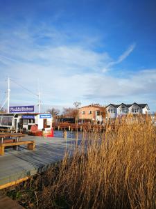 a marina with houses and a boat in the water at Rosenblick in Zingst +15 photos