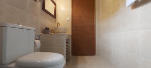 a bathroom with a white toilet and a sink at Traditional house in Asfendiou in Kos Town