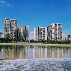 a group of tall buildings in front of a body of water at Timurbay Seaview & Poolview by Zuhayr Suite in Kuantan