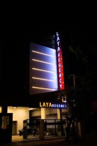 a large lit up sign in front of a building at Laya Regency in Mayiladuthurai
