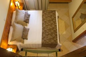 Una cama o camas en una habitación de Refugio do Saci Hotel