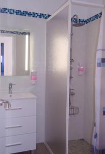 a white bathroom with a shower and a sink at V.V. Casa Quintero in Tigaday