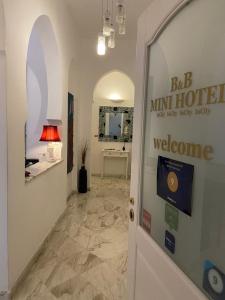 a hallway with a welcome sign on the door at B&B Mini Hotel Incity-close train station and port- in Salerno