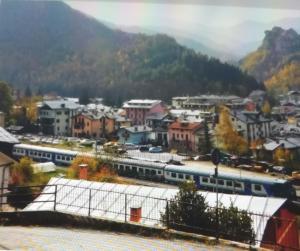 a train is parked at a train station in a town at Casa Ciliegia in Vernante