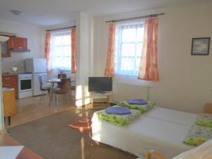 a living room with two beds and a kitchen at Wellness Penzion Lázně Jablonec in Jablonec nad Nisou