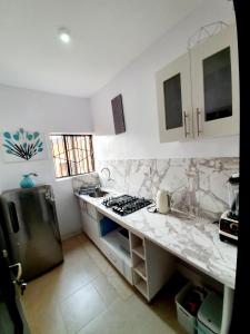 a kitchen with a stove and a counter top at Epic Prime Apartments in Ikeja
