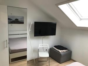 a bedroom with a flat screen tv on the wall at Ferienapartment Resi in Willingen