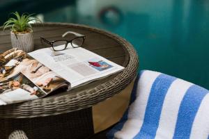 a wicker table with a magazine and glasses on it at Beachlands Hotel in Weston-super-Mare