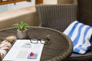 a table with a book and glasses on it at Beachlands Hotel in Weston-super-Mare