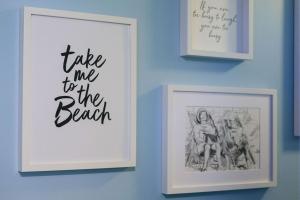 three framed pictures on a wall with a picture of a girl at Beachlands Hotel in Weston-super-Mare