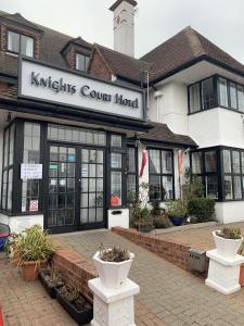 a kiltts court hotel with plants in front of it at Knights Court in Great Yarmouth