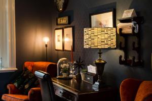 a living room with a desk and a chair at Beachlands Hotel in Weston-super-Mare