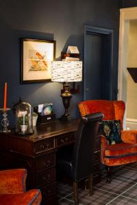 an office with a desk and a chair and a lamp at Beachlands Hotel in Weston-super-Mare