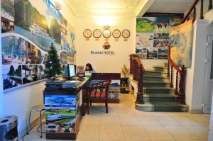 a store with stairs and clocks on the wall at Bluebell Hotel in Hanoi