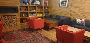 a living room with a couch and a table and chairs at Apartment at White Lavina Hotel in Bansko +4 photos