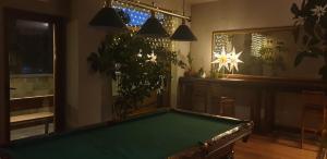 a pool table in a living room with plants at Apartment at White Lavina Hotel in Bansko