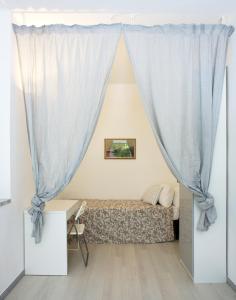 ein Schlafzimmer mit einem Bett und einem Vorhang in der Unterkunft Cà de Lerse in Lerici