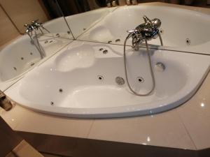 a white bath tub with a faucet on a counter at Apartament Równica in Ustroń