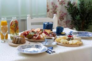 a table with plates of food on a table at Apartment Dadi in Cetinje