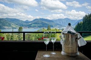 two glasses of wine on a table with a view at Freihaus Brenner in Bad Wiessee