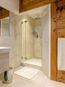 a shower with a glass door in a bathroom at Freihaus Brenner in Bad Wiessee