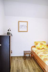 um pequeno quarto com uma cama e uma mesa em Apartments Nikčević em Budva