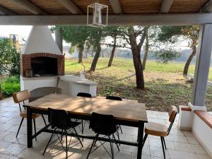 a table and chairs on a patio with a fireplace at Trullo Labellavita in Putignano