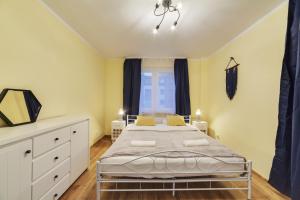 a bedroom with a large bed and a window at Dream Loft Podwale Staromiejskie in Gdańsk