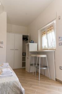 a bedroom with a bed and a table and a stool at Blu Palinuro in Palinuro