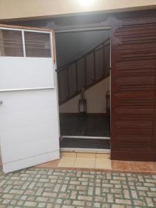 an open door to a garage with a staircase at Apartamento 11 Tec in Cartago