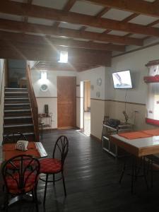 a living room with a table and chairs and a staircase at Apartamento 11 Tec in Cartago