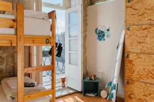a room with bunk beds and a window at Happy Porto Hostel & Apartments in Porto