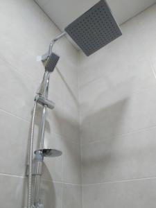 a shower with a shower head in a bathroom at Petit Dilijan in Dilijan