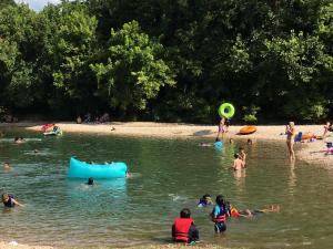 a group of people in the water at a beach at Cassville Four Seasons Inn & Suites in Cassville