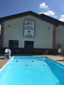 einem Pool vor einem Gebäude mit Schild in der Unterkunft Cassville Four Seasons Inn & Suites in Cassville
