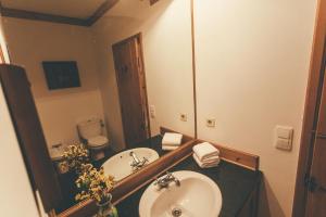 a bathroom with two sinks and a large mirror at BayView House in Angra do Heroísmo +17 photos