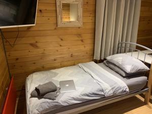 a bedroom with a bed with a laptop on it at Southernwood - Garden Lodge 5 in Didcot