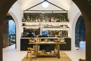 a bar in a room with arched windows at Kamezí Boutique Hotel Villas in Playa Blanca +39 photos