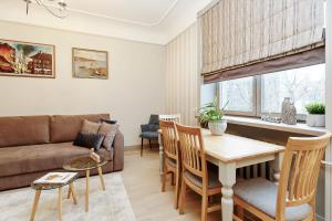 a living room with a couch and a table at Old town Kalku Apartment in Rīga