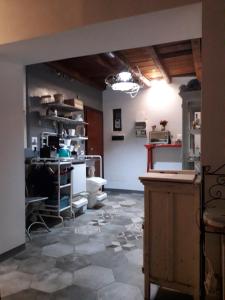 a room with a stone floor and a room with a table at B&B Castellani in Pavia