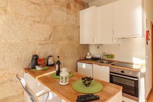 a kitchen with a stove a sink and a dishwasher at Happy Porto Hostel & Apartments in Porto